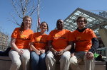 People seated in orange shirts 