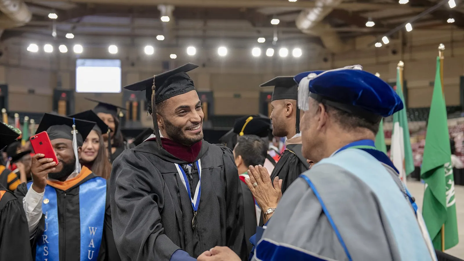 Students shaking hands at graduation