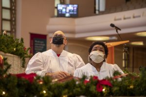 Antonica Neto looks up at her friends and family in Zoom projected on the screens at Sligo Seventh-day Adventist Church before being baptized by Richard Castillo. 
